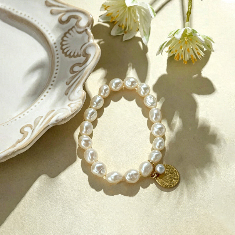 close up of hammered gold coin texture and natural rice pearls on Loxun gardener bracelet
