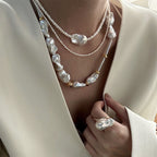 Loxun layered baroque pearl necklace stacked with a gold chain and other pearls layered effortless style