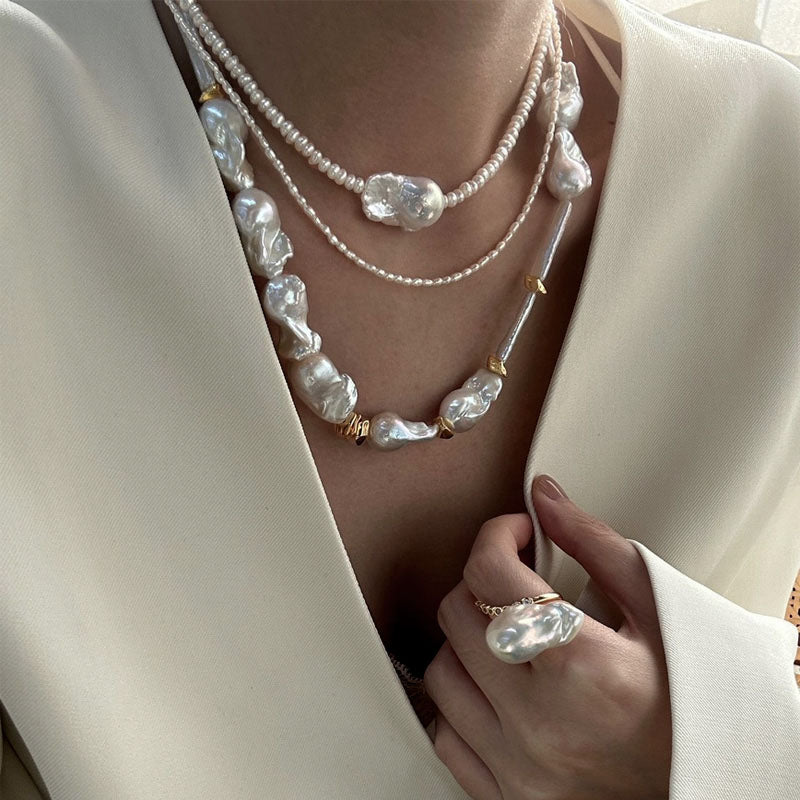 Loxun layered baroque pearl necklace stacked with a gold chain and other pearls layered effortless style