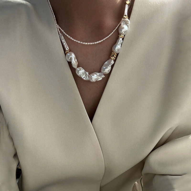 Loxun layered baroque pearl necklace stacked with a gold chain and other pearls layered effortless style