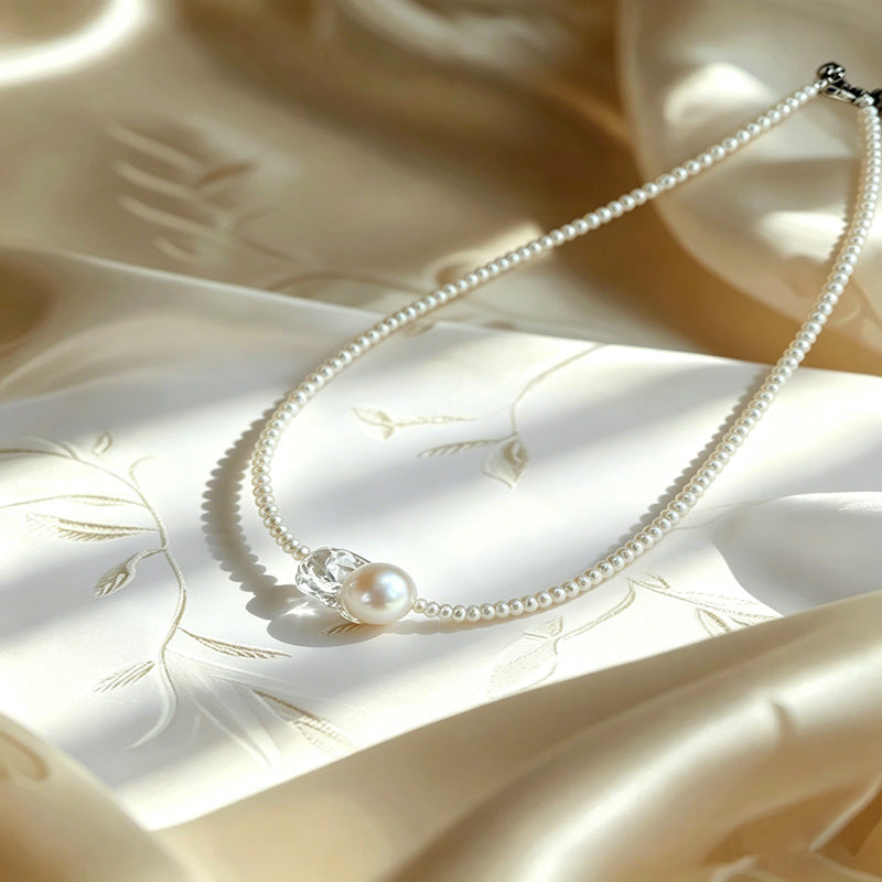close up of natural rice pearls and oversized keshi baroque pearl on Loxun graduated necklace