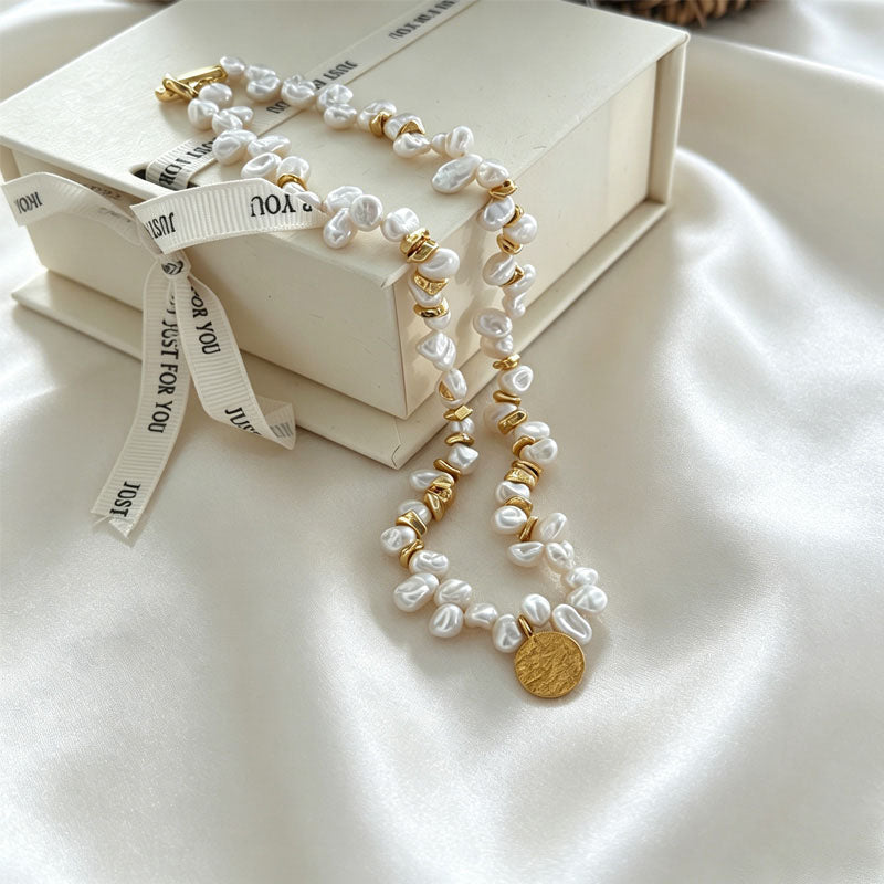 close up of natural keshi pearl irregular texture and gold medal pendant on Loxun necklace