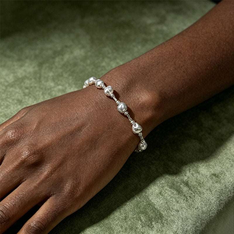 close up of Loxun crushed silver bracelet on wrist textured beads sterling silver hypoallergenic
