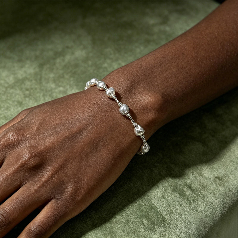 close up of Loxun crushed silver bracelet on wrist textured beads sterling silver hypoallergenic
