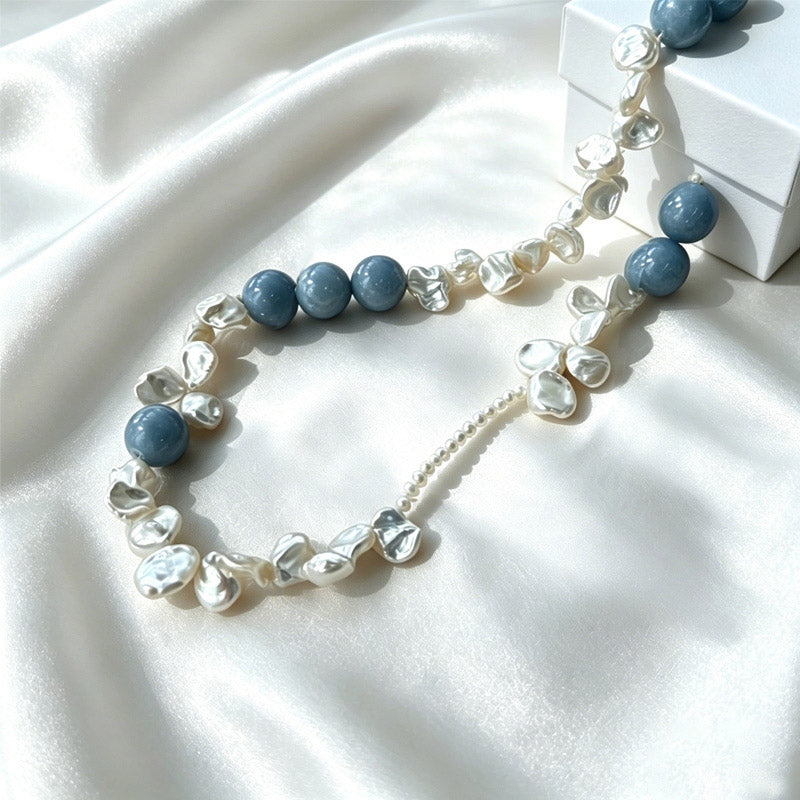 close up of natural blue petal stone veining and baroque pearl texture on Loxun necklace