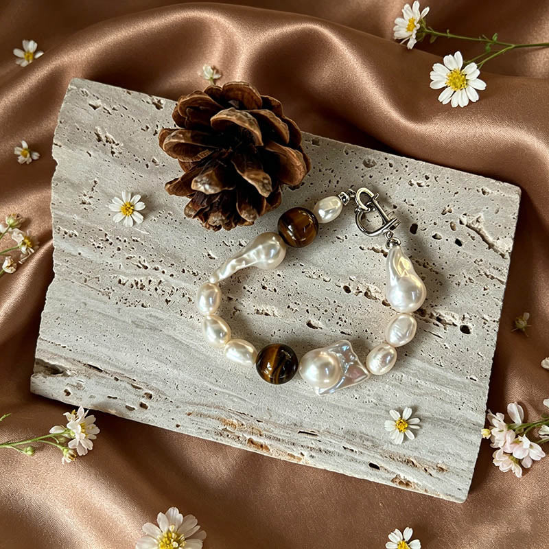 close up of natural tiger eye stripes and baroque keshi pearl luster on Loxun necklace