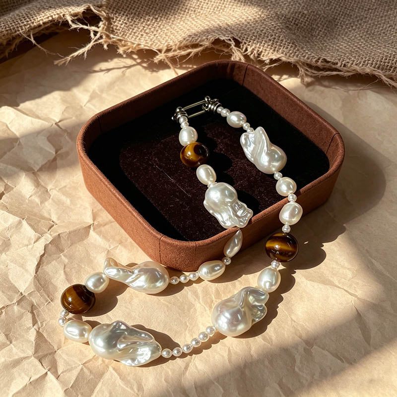 close up of natural tiger eye stripes and baroque keshi pearl luster on Loxun necklace