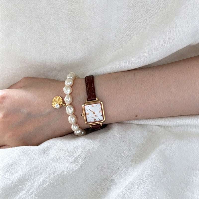 woman wearing Loxun gardener rice pearl  bracelet with gold coin on wrist S/M size