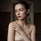woman wearing Loxun asymmetrical pearl ring on finger baroque and round pearl gold stacked with other rings