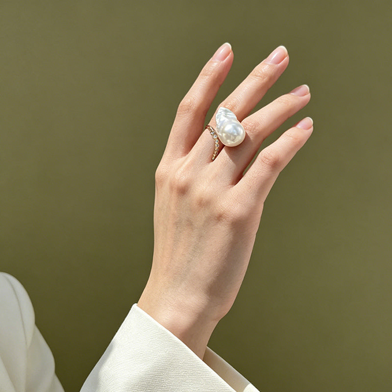 woman wearing Loxun baroque pearl ring on finger cold tone lariat stacking with gold rings