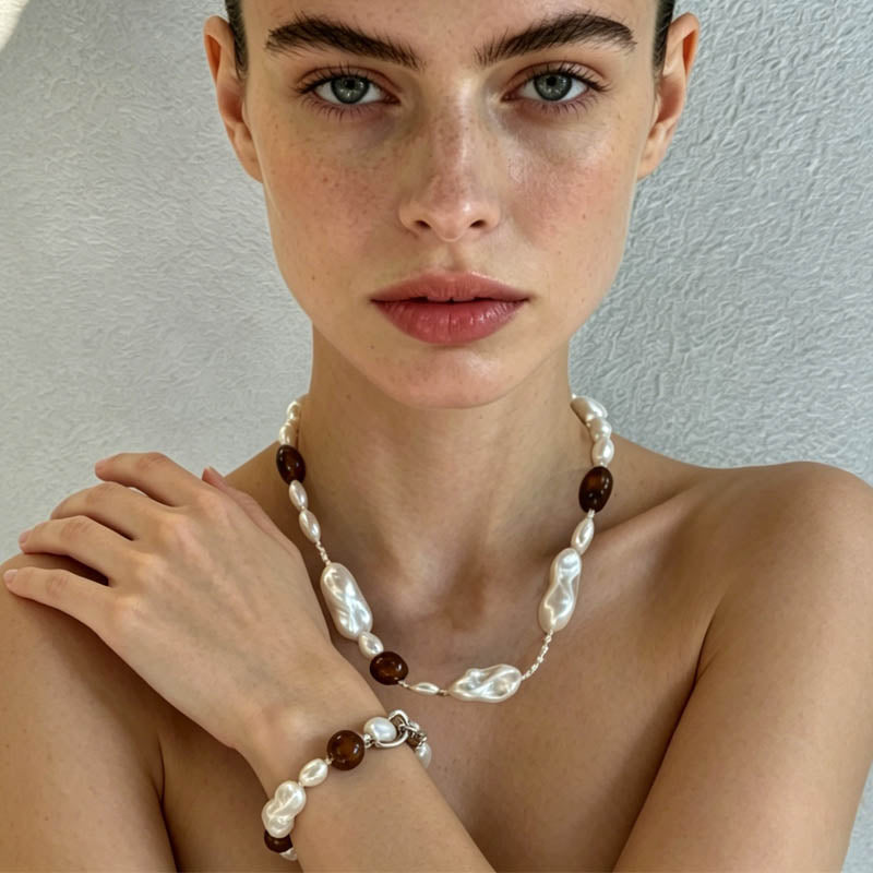 woman wearing Loxun tiger eye and baroque pearl necklace adjustable sterling silver vintage style